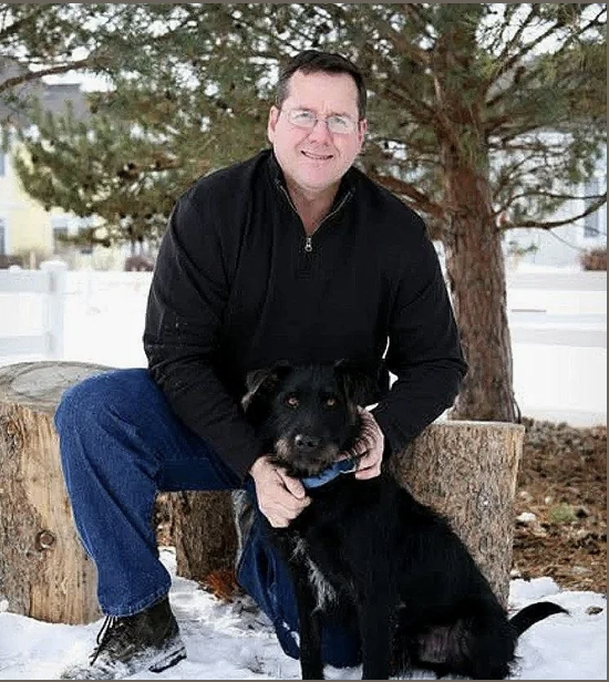 Team portrait outdoors with a dog