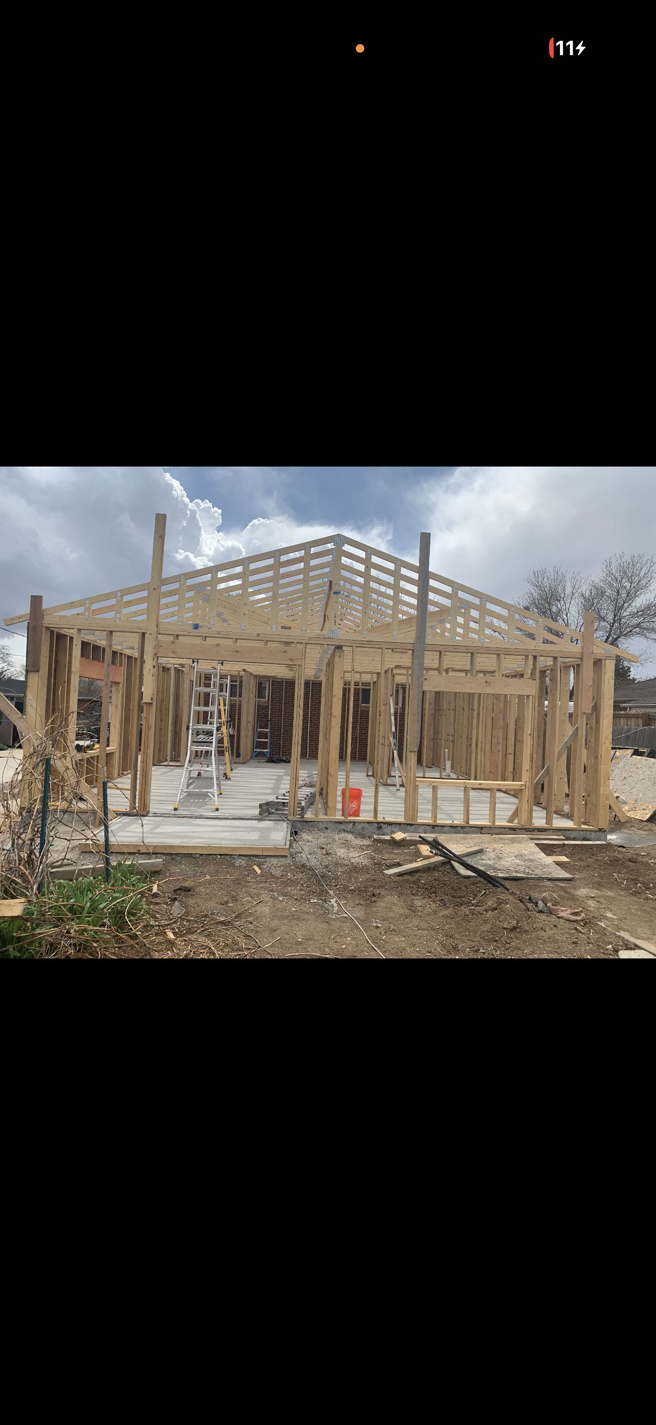Wall framing and roof trusses during construction.